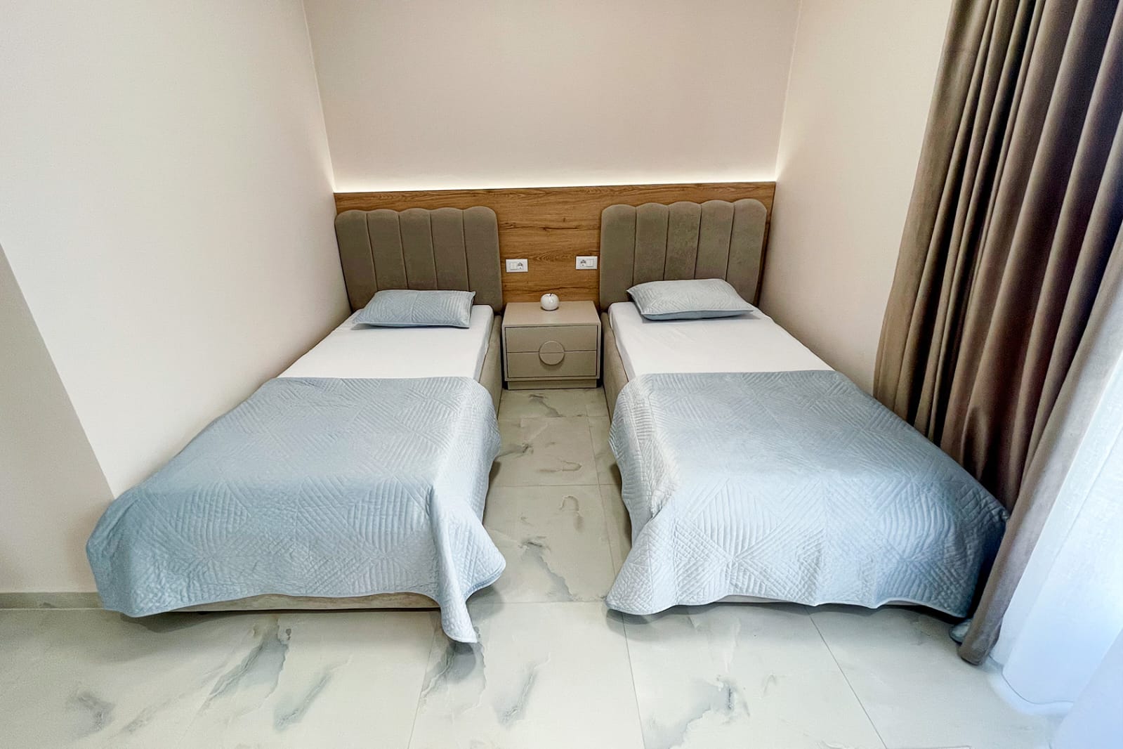 Second bedroom — twin beds with bedside table