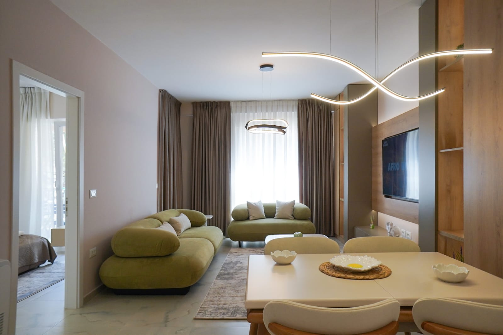 Living and dining space with designer lighting